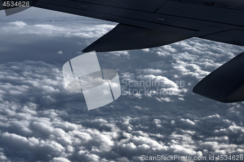 Image of Large airliner along clouds