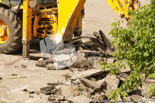 Image of Tractor Dismantles Asphalt