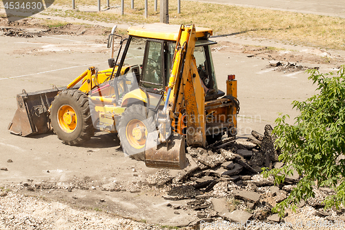 Image of Tractor Dismantles Asphalt