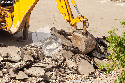 Image of Tractor Dismantles Asphalt