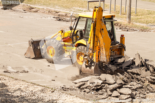 Image of Tractor Dismantles Asphalt