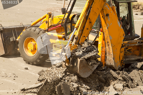 Image of Tractor Dismantles Asphalt