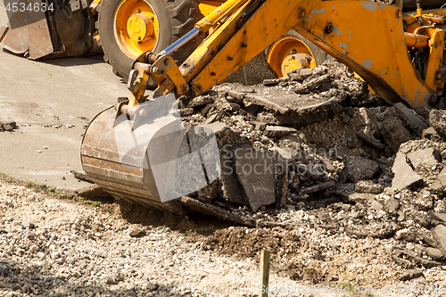 Image of Tractor Dismantles Asphalt