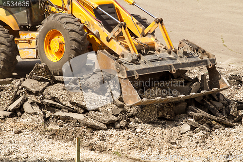 Image of Tractor Dismantles Asphalt