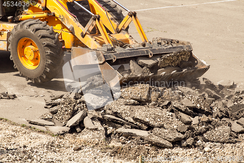 Image of Tractor Dismantles Asphalt