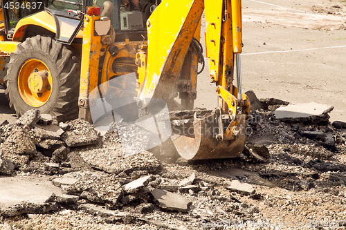 Image of Tractor Dismantles Asphalt