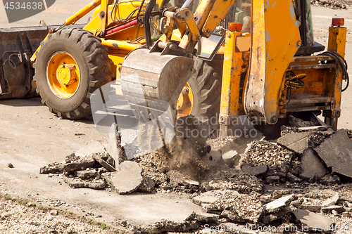 Image of Tractor Dismantles Asphalt