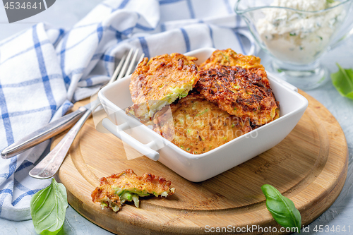 Image of Zucchini pancakes with sour cream sauce.