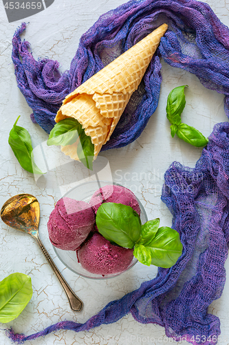 Image of Artisanal blueberry ice cream with green basil.