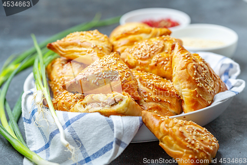 Image of Homemade samosas with meat and spices.