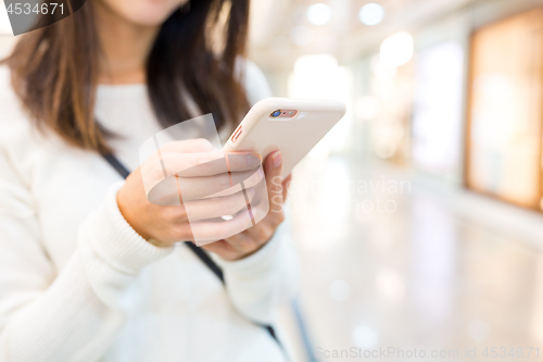 Image of Woman sending text message on mobile phone