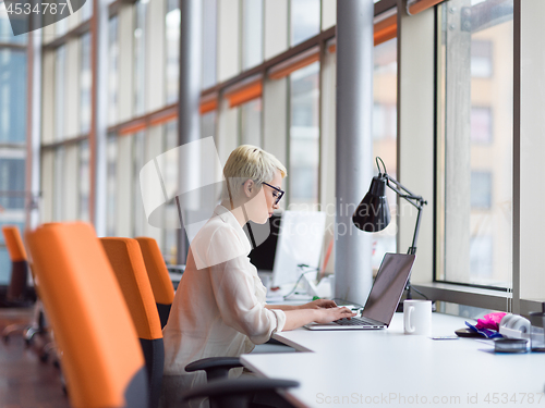 Image of businesswoman using a laptop in startup office