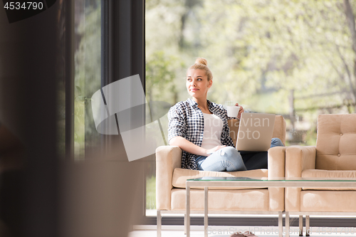 Image of woman drinking coffee enjoying relaxing lifestyle