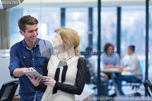 Image of Business People Working With Tablet in startup office