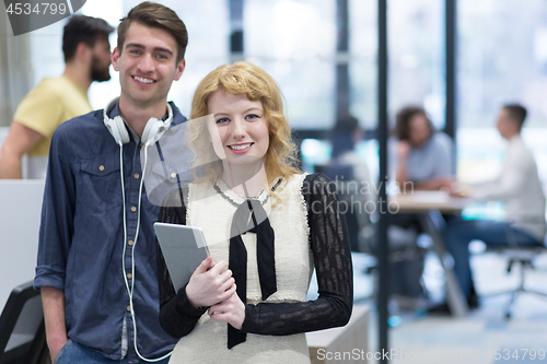 Image of Business People Working With Tablet in startup office