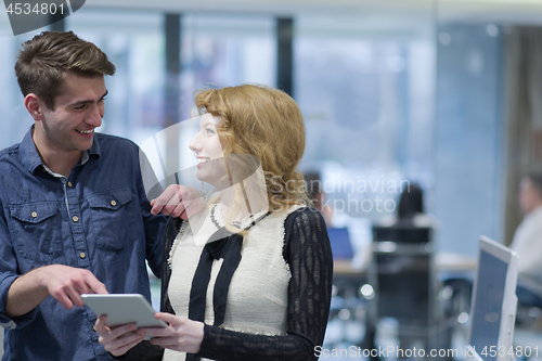 Image of Business People Working With Tablet in startup office