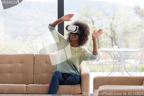 Image of black woman using VR headset glasses of virtual reality