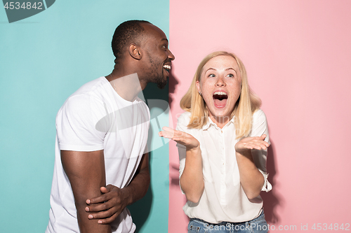 Image of happy afro man and woman. Dynamic image of caucasian female and afro male model on pink studio.