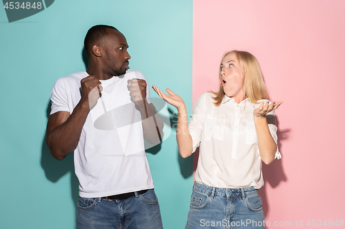 Image of Beautiful woman and afro woman looking suprised isolated on pink