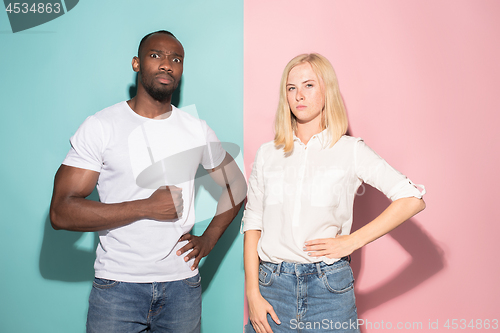 Image of Portrait of an angry woman looking at camera isolated on a pink background