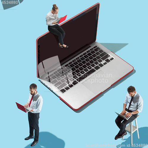 Image of Flat isometric view of businessmen and woman showing at laptop with empty screen.