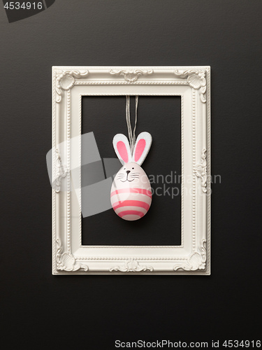 Image of a happy easter decoration with a bunny egg in a frame