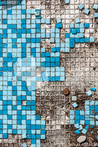 Image of broken basin with blue small tiles