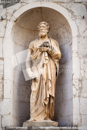 Image of ancient stone Saint Peter statue at Assisi Marche Italy