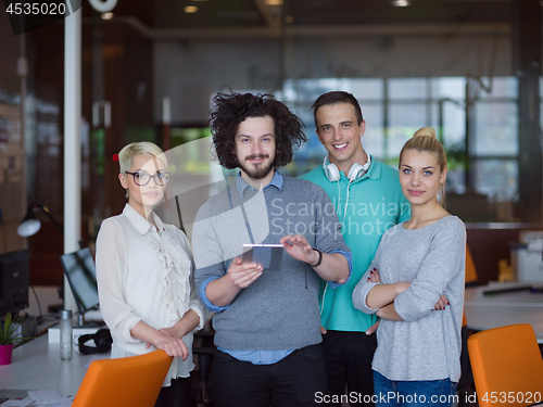 Image of group of Business People Working With Tablet in startup office