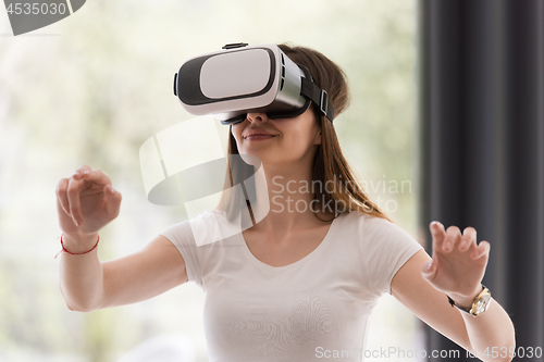 Image of woman using VR-headset glasses of virtual reality