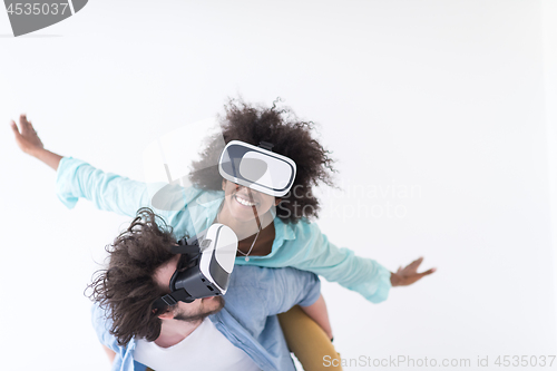 Image of multiethnic couple getting experience using VR headset glasses