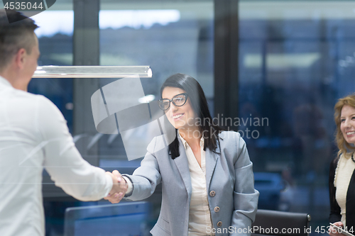 Image of cloasing the deal in modern office interior