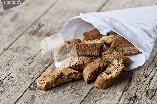 Image of Traditional Italian cookies cantuccini on white paper bag on ruc