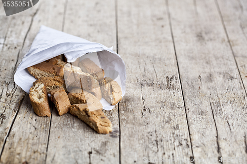 Image of Traditional Italian cookies cantuccini on white paper bag on ruc