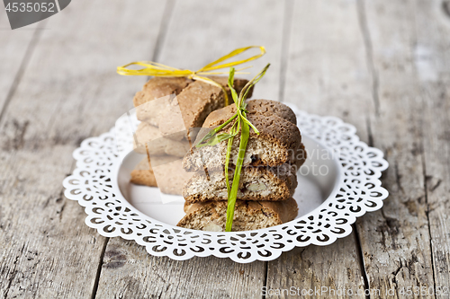 Image of Fresh Italian cookies cantuccini on white plate on ructic wooden