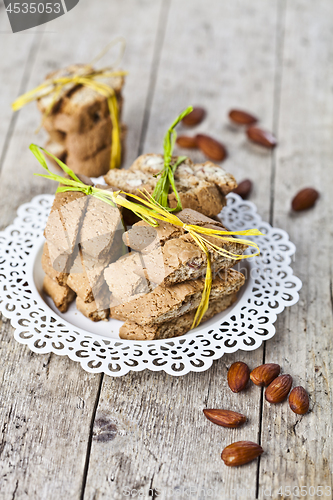 Image of Fresh Italian cookies cantuccini stacked on white plate and almo