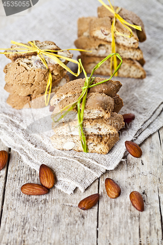 Image of Fresh Italian cookies cantuccini stacks and almond nuts on linen