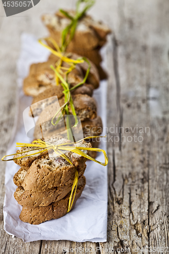 Image of Fresh Italian cookies cantuccini stackes and white paper on ruct