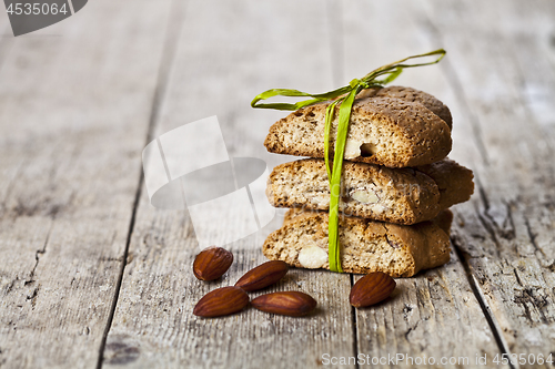 Image of Fresh Italian cookies cantuccini stack and almond nuts on ructic