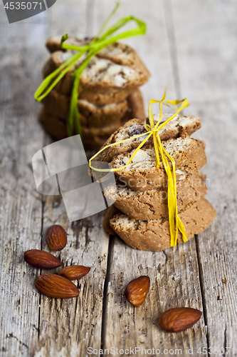 Image of Fresh Italian cookies cantuccini stackes and almond nuts on ruct