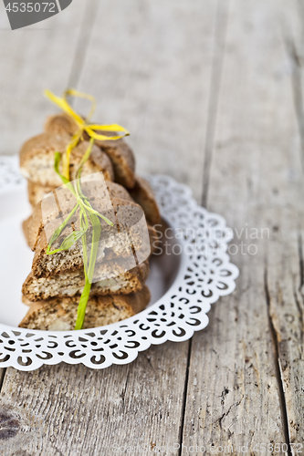 Image of Fresh homemade Italian cookies cantuccini stacked on white plate