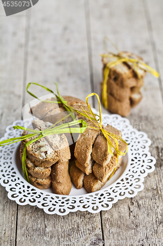 Image of Fresh homemade Italian cookies cantuccini stacked on white plate