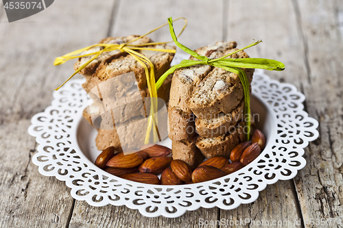 Image of Almond seeds and fresh Italian cookies cantuccini stacked on whi