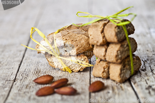 Image of Fresh Italian cookies cantuccini stacks and almond seeds on ruct