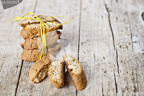 Image of Fresh Italian cookies cantuccini stack and almond seeds on ructi