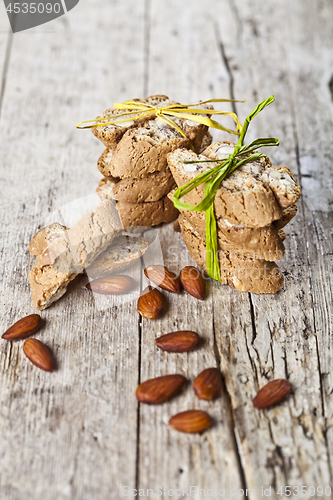 Image of Fresh Italian cookies cantuccini stackes and almond seeds on ruc