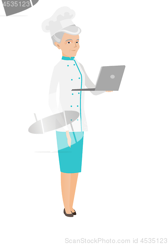 Image of Seinor caucasian chef cook using a laptop.