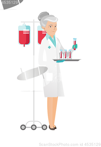 Image of Laboratory assistant analyzing blood in test tube.