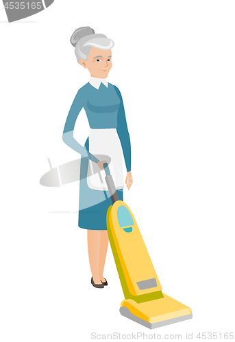 Image of Chambermaid cleaning floor with a vacuum cleaner.