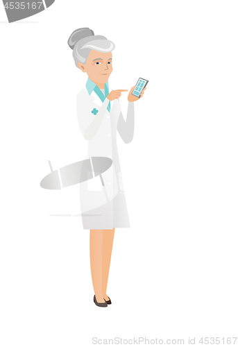 Image of Senior caucasian doctor holding a mobile phone.